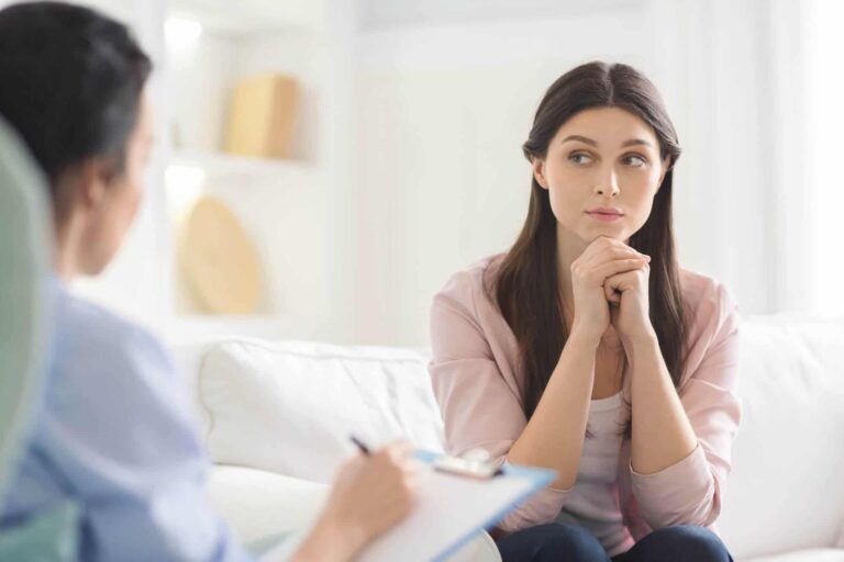 A young woman listening carefully during a therapy session
